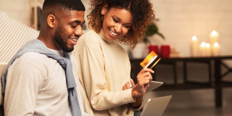 image of couple with banking card for black owned banks